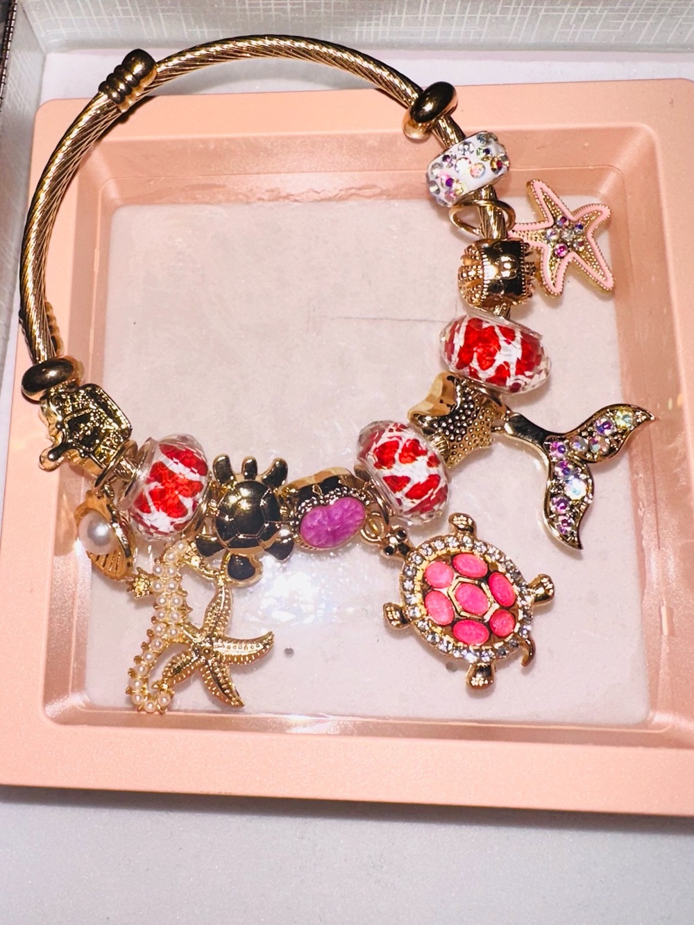 Gold Tone Sea Life Charm Bracelet with Pink and Red Accents
